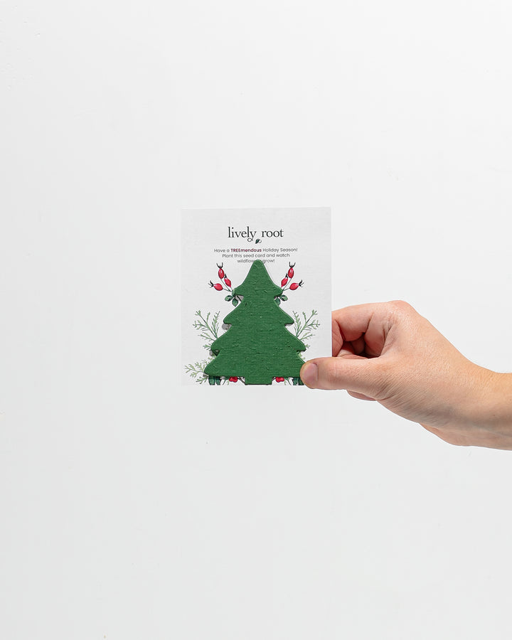 Green tree-shaped holiday seed paper card featuring festive botanical design and holiday message, eco-friendly plantable greeting card for seasonal greetings and wildflower gardening.