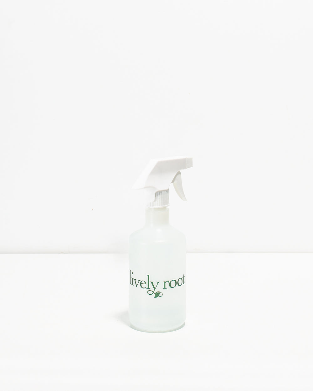 A clear plastic plant mister with a white spray nozzle and a label that reads 'Lively Root'.
