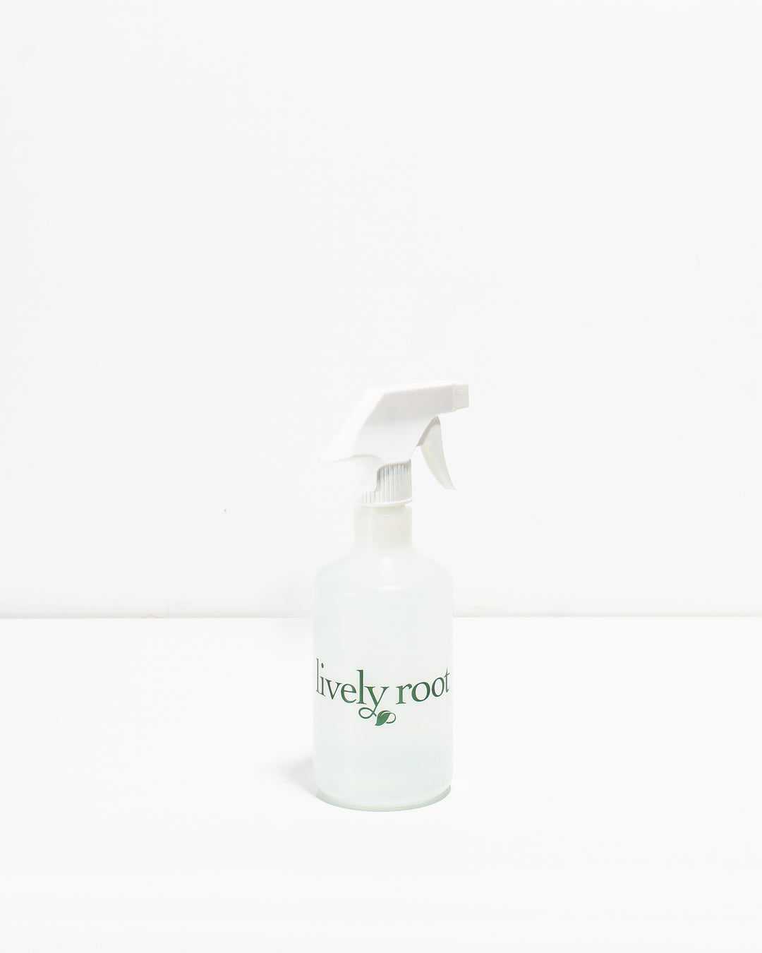 A clear plastic plant mister with a white spray nozzle and a label that reads 'Lively Root'.