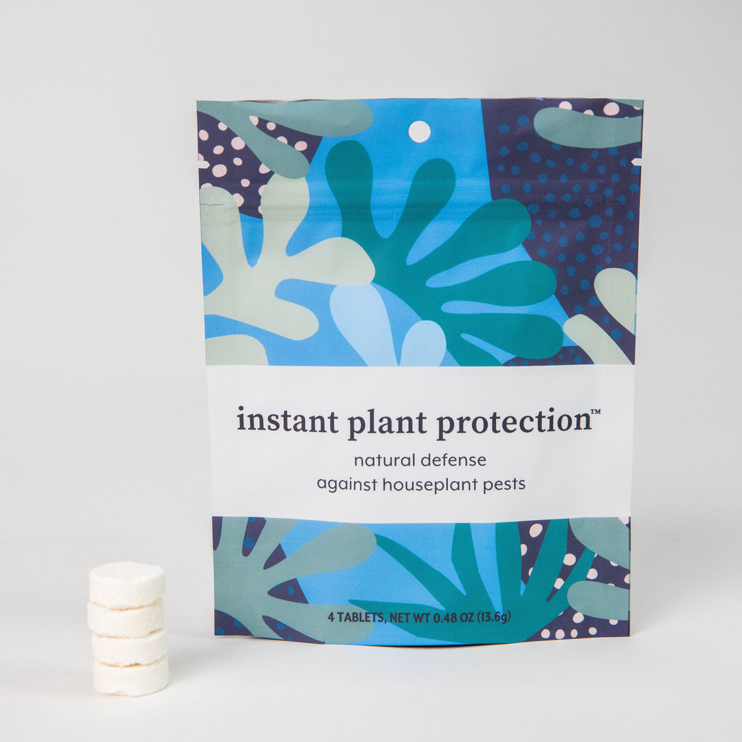 Instant Plant Protection 4-tablet pouch standing upright next to a stacked column of white pest control tablets on a plain background