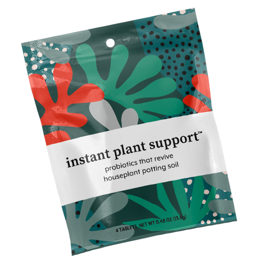 Instant Plant Support sachet with eye-catching botanical design in teal and red featuring text describing probiotics that revive houseplant potting soil, compact tablet format for convenient indoor plant soil amendment and microbial restoration.